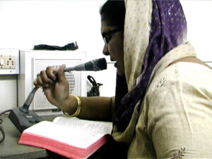 Female Chaplain Leading Intercom Prayers